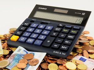 calculator on coin pile